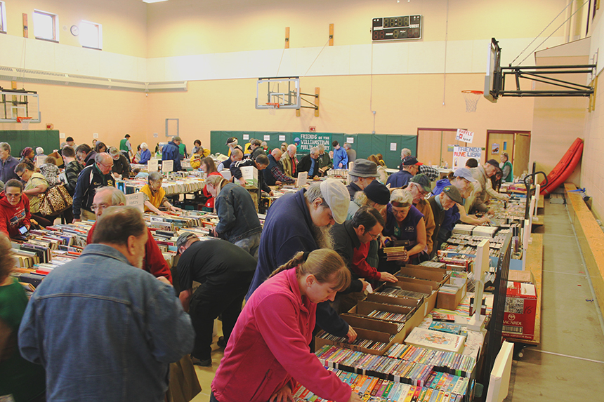 Bibliophiles eagerly pick through stacks of thousands of books hunting for literary treasures at the 2016 Friends of the David and Joyce Milne Public Library; photo courtesy FDJMPL.