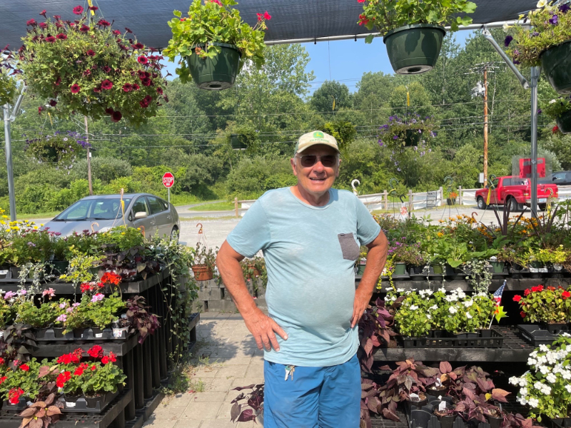 Photo of Dan Tawczynski, owner of Taft Farm, standing in one of his greenhouses.