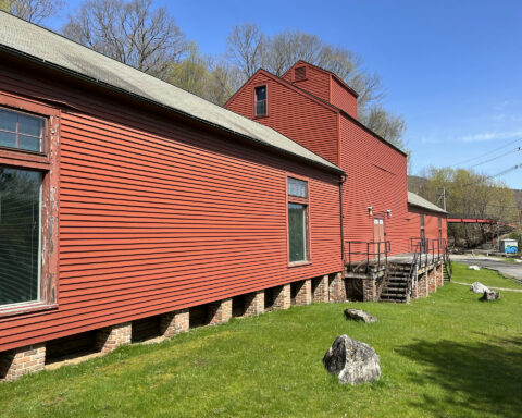 Exterior photo of long, wood sided, building that now houses the Berkshires Academy for Advanced Musical Studies.