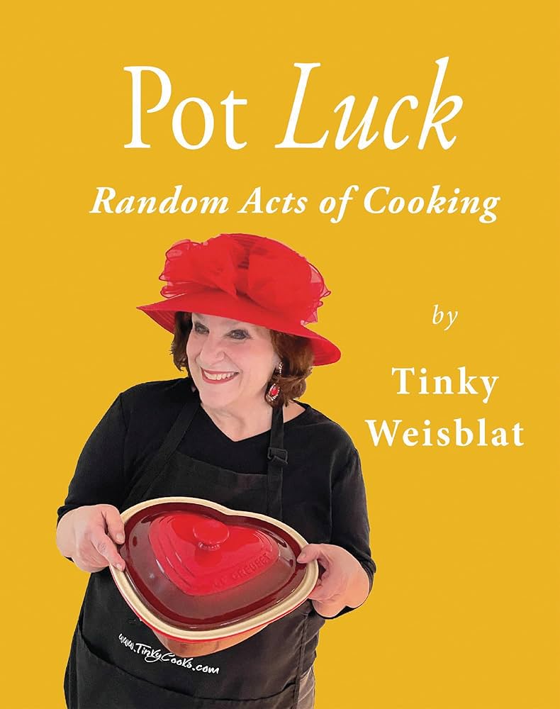 Cover of the book Pot Luck: Random Acts of Cooking by Tinky Weisblat. The background is a bright, jaunty yellow. The title appears in large white serif lettering at the top. Below it, Tinky Weisblat is pictured smiling, wearing a black knit top and a black apron. She holds a red, heart-shaped casserole dish in front of her. Her name appears at the bottom of the cover in smaller white text.