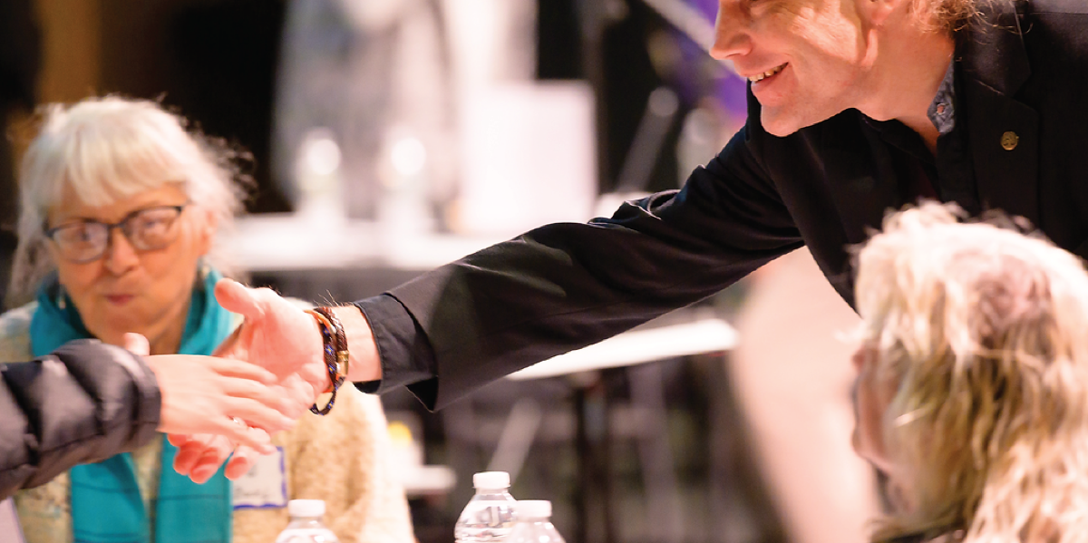 Participants greet one another during an Adams Theater MA250 Festival program image.