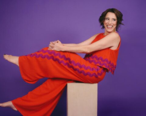 Judy Kuhn reclining in a red dress in promotional portrait for Barrington Stage Company cabaret performance in Pittsfield