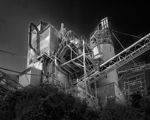 Black-and-white photograph of industrial structures at the Specialty Minerals plant in Adams.